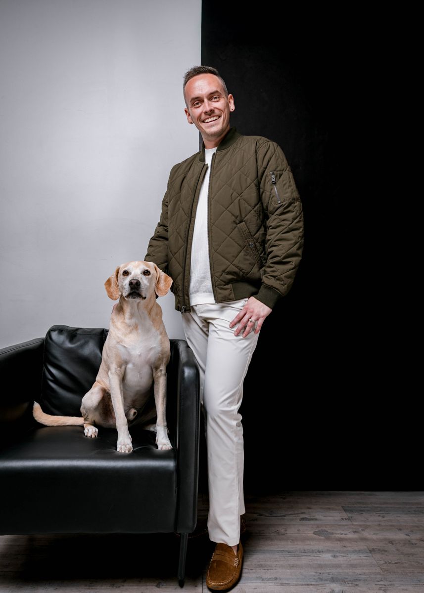 Tyler standing beside his Lab mix