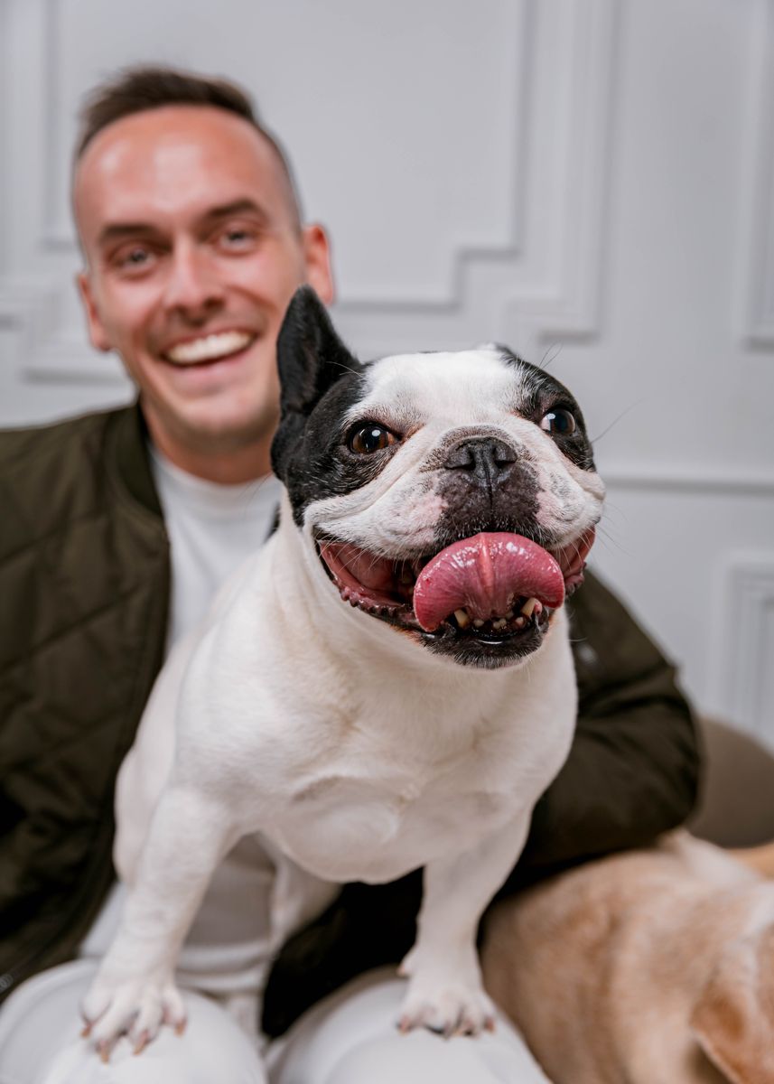 Tyler laughing with his pied French bulldog