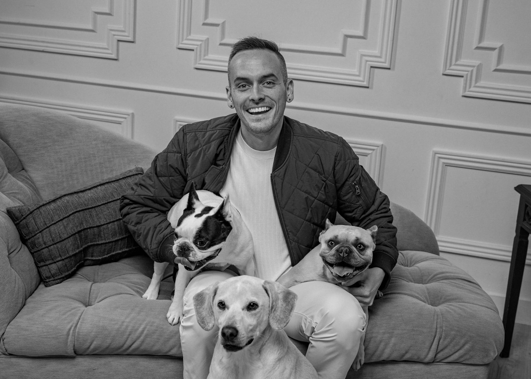 Tyler on a chaise with his three dogs