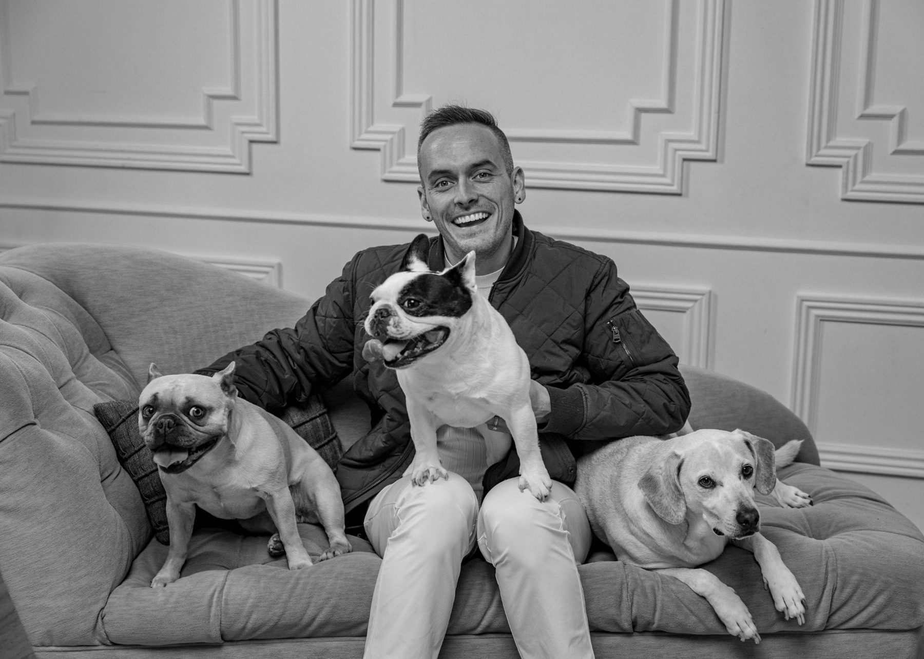Tyler on a sofa with his three dogs