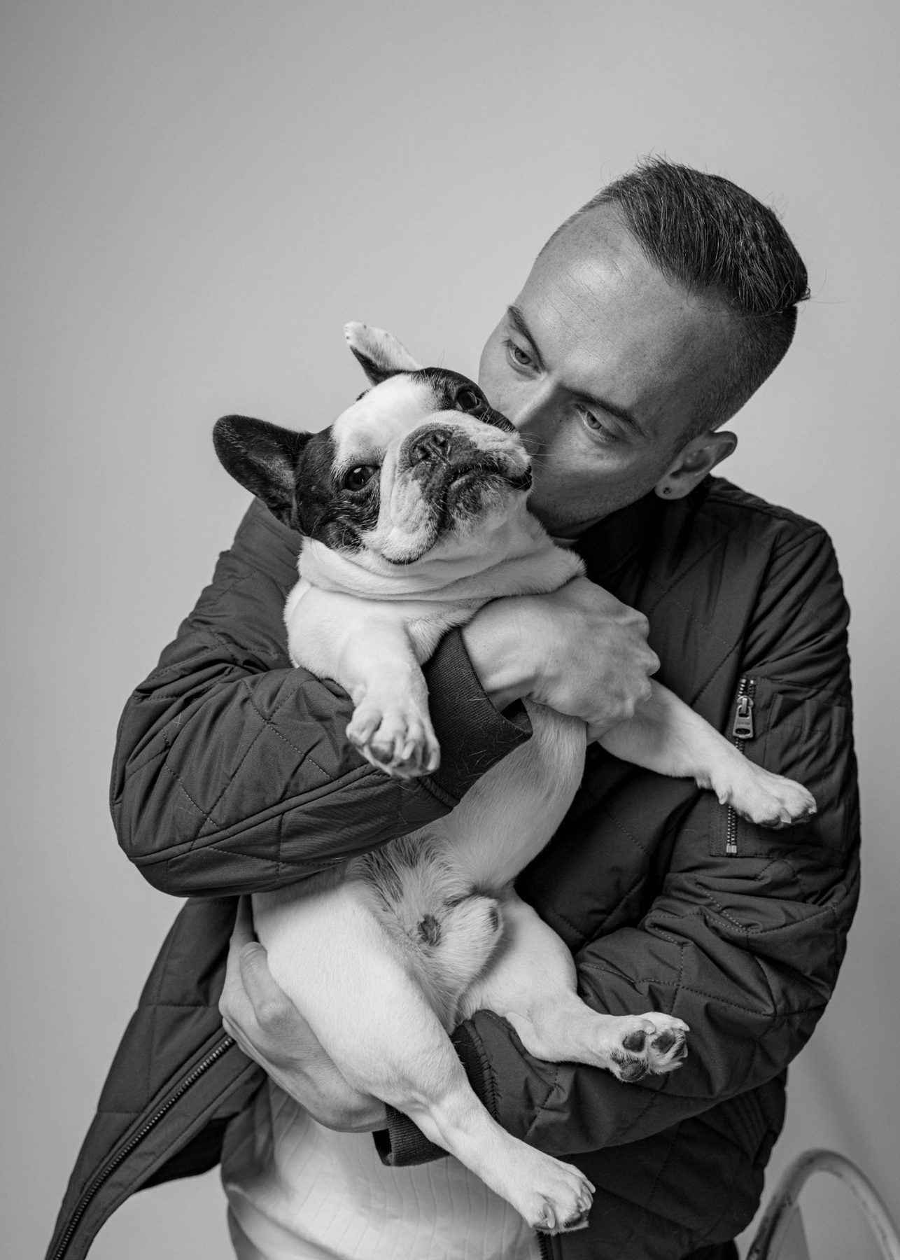 Tyler kissing his fawn French bulldog
