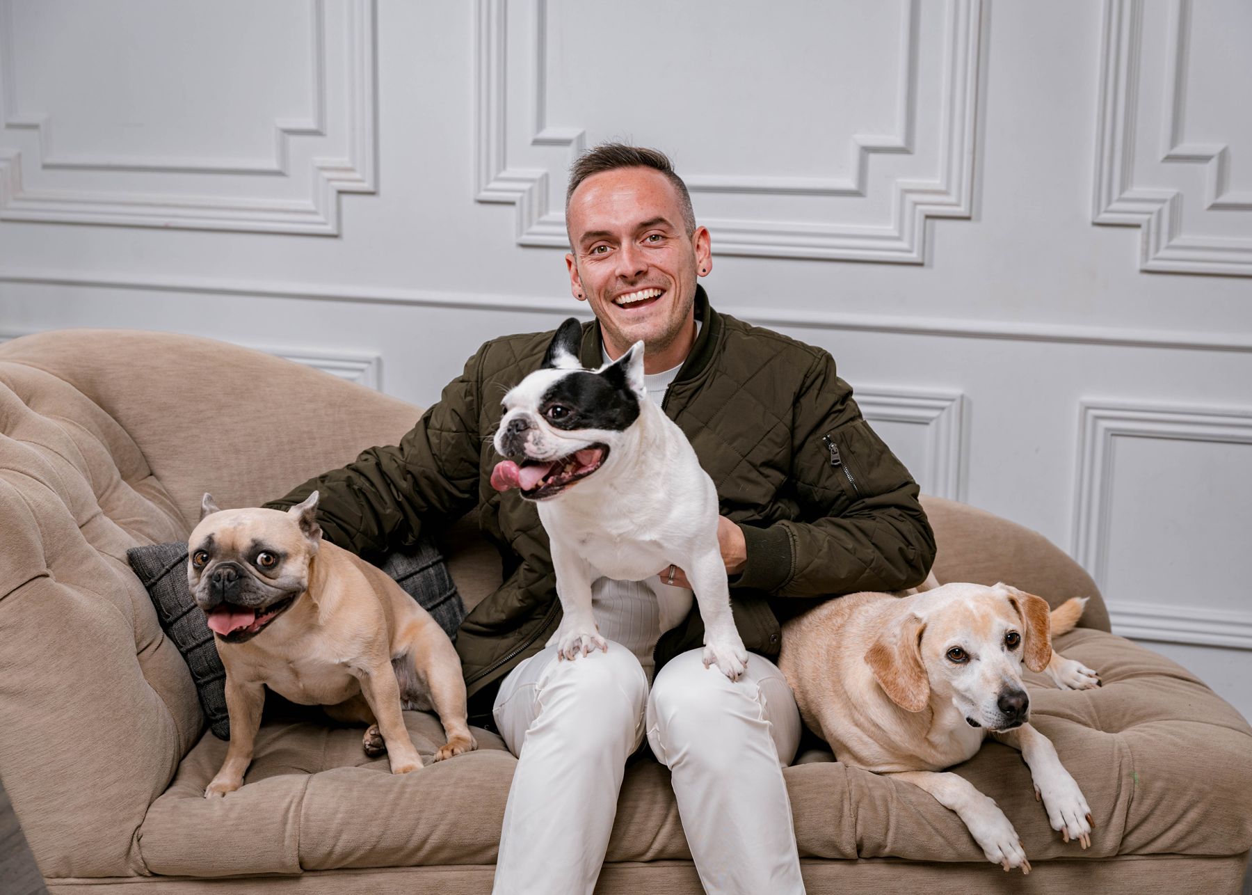 Tyler on a chaise with his three dogs