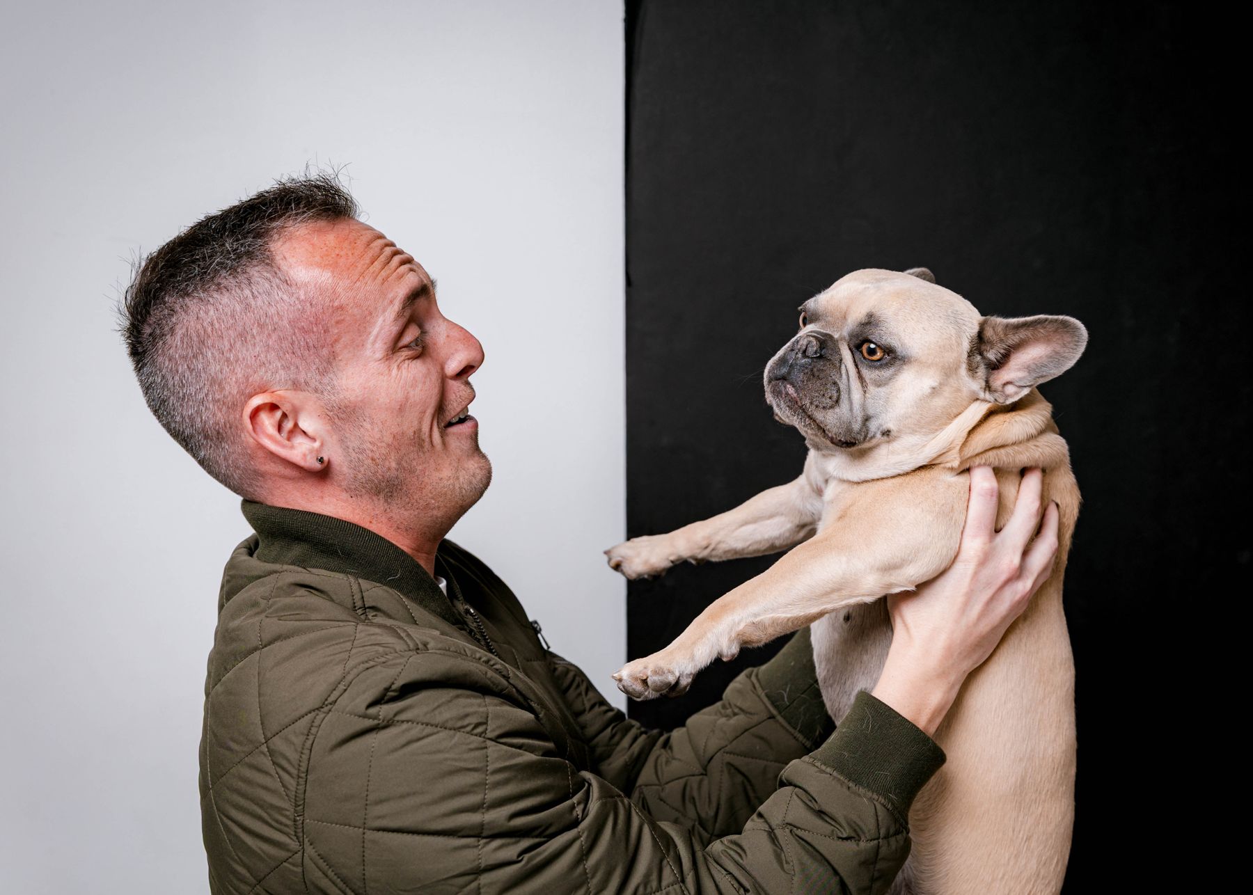 Tyler lifting his fawn French bulldog